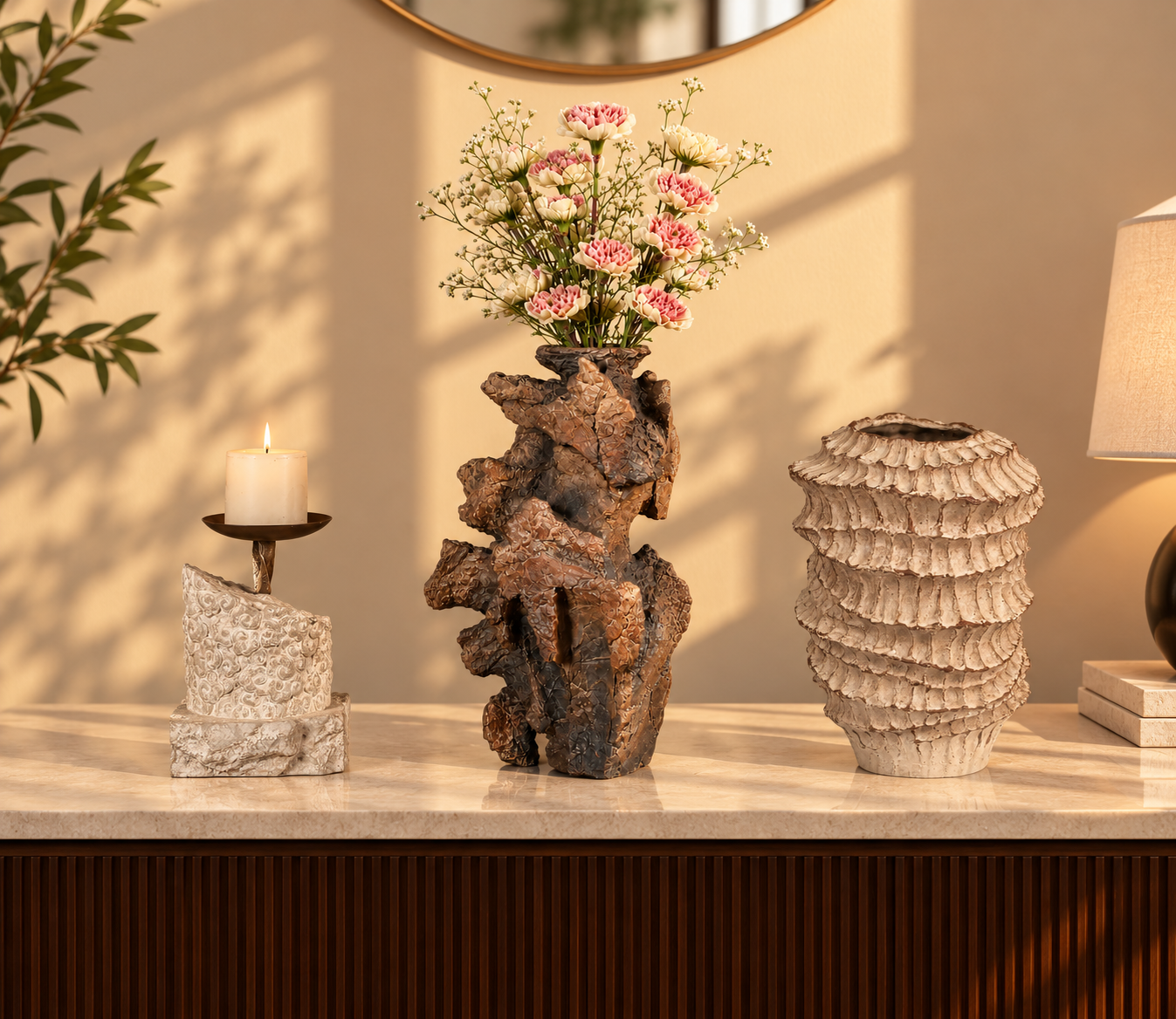 Styled console with candle holder, bark vase and amber vase